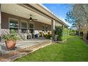 Landscaped backyard with a covered patio and grassy area at 3558 Nw 56Th Ave, Ocala, FL 34482
