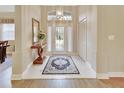 Bright and airy entryway with hardwood floors and a large front door at 376 Hampton Hills Ct, Debary, FL 32713