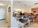 Kitchen with breakfast bar, stainless steel appliances, and white cabinets at 3800 S Atlantic Ave # 4080, Daytona Beach, FL 32118