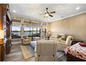 Relaxing living room with lake views, comfortable seating, and hardwood floors at 524 Quail Hill Dr, Debary, FL 32713