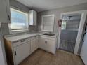 Small kitchen with white cabinets, marble countertops, and tile floor at 610 Division St, Daytona Beach, FL 32114