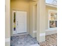 White front door with a stone floor and sidelights at 981 Wilmington Dr, Deltona, FL 32725