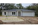 Newly constructed single-Gathering home with a gray exterior at 1205 2Nd St, Orange City, FL 32763