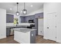 Modern kitchen featuring gray cabinets, granite countertops, and stainless steel appliances at 1205 2Nd St, Orange City, FL 32763