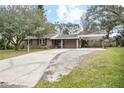 Front view of a ranch house with a carport at 139 Floridana Rd, Debary, FL 32713