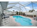 Relaxing screened pool with patio furniture in backyard at 15 Longfellow Cir, Ormond Beach, FL 32176