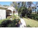 Landscaped walkway leading to the house entrance at 1525 E Silver Hammock, Deland, FL 32720