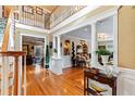 Spacious entryway with hardwood floors and a double staircase at 163 Laurelwood Ln, Ormond Beach, FL 32174