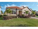 Landscaped lawn and palm trees surround this house at 167 Ancona Ave, Debary, FL 32713