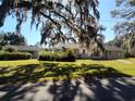 House with a spacious yard, detached garage, and lush trees at 1848 Ridgewood St, Deland, FL 32720