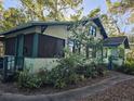 House with a large yard and mature trees surrounding it at 1937 N Spring Garden Ave, Deland, FL 32720