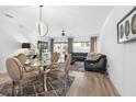 Elegant dining room with glass table and modern chairs at 2353 Carrabelle Way, Sanford, FL 32771