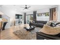 Spacious living room featuring a modern sectional sofa and large TV at 2353 Carrabelle Way, Sanford, FL 32771
