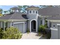 Gray exterior with a unique turret and a paved driveway at 2423 Wild Turkey Creek Ln, Port Orange, FL 32128