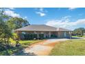 Brick ranch home with large yard and curved driveway at 2501 Alton Rd, Deltona, FL 32738