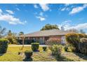 Brick house with well-manicured lawn and landscaping at 2501 Alton Rd, Deltona, FL 32738