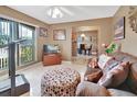 Living room with tiled floor, brown couch, and view of dining area at 2994 Annez Way, Debary, FL 32713