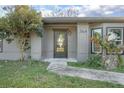 Modern front door with glass panels and a neutral color palette at 3164 Chamberlain St, Deltona, FL 32738
