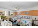 Bright bedroom with two double beds, coastal decor, and plenty of light at 3509 S Atlantic Ave # 301, New Smyrna Beach, FL 32169