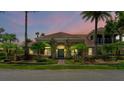 Two-story house with a tile roof, landscaping, and a walkway at 3548 Tuscany Reserve Blvd, New Smyrna Beach, FL 32168