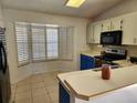 Bright kitchen with white cabinets and a corner window at 3566 Red Pontiac Dr, Port Orange, FL 32129