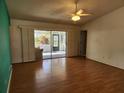 Spacious living room with wood floors and access to a screened patio at 3566 Red Pontiac Dr, Port Orange, FL 32129