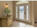 Elegant entryway with decorative cabinet and stained-glass door at 3605 Galway Ln, Ormond Beach, FL 32174
