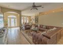 Spacious living room with a large sectional sofa and hardwood floors at 3605 Galway Ln, Ormond Beach, FL 32174