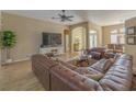Living room with hardwood floors, sectional sofa, and large TV at 3605 Galway Ln, Ormond Beach, FL 32174