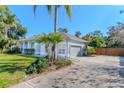 Charming single-story home with a gray facade, a well-kept lawn, and a paved driveway at 419 Still Forest Ter, Sanford, FL 32771