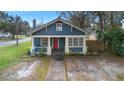 Charming bungalow with blue siding, red door, and walkway at 448 E Church St, Deland, FL 32724