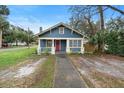 Charming bungalow with blue siding, red door, and walkway at 448 E Church St, Deland, FL 32724