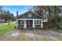 Cozy craftsman-style home with bright red door and inviting facade at 448 E Church St, Deland, FL 32724