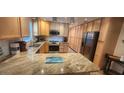 Updated kitchen boasts granite countertops and ample cabinetry at 487 Dawnview Sq, Port Orange, FL 32127