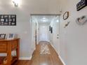 A cozy entryway features hardwood floors, a decorative rug, and neutral-colored walls at 55 Fairway Dr # 3D, Debary, FL 32713