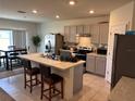 Spacious kitchen with an island, stainless steel appliances, and a dining area at 600 Auburn Grove Ter, Auburndale, FL 33823