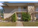 Condo exterior with walkway, stairs, and lush landscaping at 689 Wellington Station Blvd # 41, Ormond Beach, FL 32174