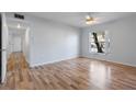 Bright living room with laminate floors and large window at 689 Wellington Station Blvd # 41, Ormond Beach, FL 32174