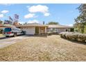 Brick ranch house with carport, landscaping, and large yard at 783 S Atmore Cir, Deltona, FL 32725