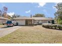 Brick ranch house with carport, landscaping, and large yard at 783 S Atmore Cir, Deltona, FL 32725