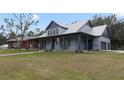 Gray farmhouse with wraparound porch and stone accents at 1330 E Taylor Rd, Deland, FL 32724