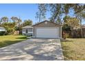 House exterior showcasing a garage and landscaping at 1768 Santee Ave, Deltona, FL 32738