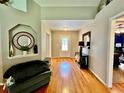 Welcoming entryway with hardwood floors and decorative niche with accent lighting at 1900 Knolton Ave, Orange City, FL 32763