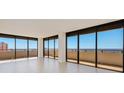 Spacious living room with wall-to-wall windows and ocean view at 2200 N Atlantic Ave # 1502, Daytona Beach, FL 32118