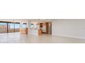 Open concept living room and kitchen with tile floors at 2200 N Atlantic Ave # 1502, Daytona Beach, FL 32118
