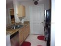 Kitchen with granite countertops, stainless steel appliances, and wood cabinets at 2770 Coastal Bay Dr # 3-103, Orange City, FL 32763