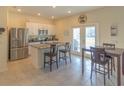Open kitchen features stainless steel appliances and breakfast bar at 3033 Meleto Blvd, New Smyrna Beach, FL 32168