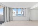Living room with ocean view and floor-to-ceiling windows at 3047 S Atlantic Ave # 1906, Daytona Beach, FL 32118