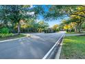 Residential street with lush landscaping and guard house entrance at 310 La Creek Ct, Debary, FL 32713