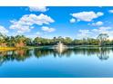 Serene lake with fountain and lush greenery reflecting in the water at 310 La Creek Ct, Debary, FL 32713